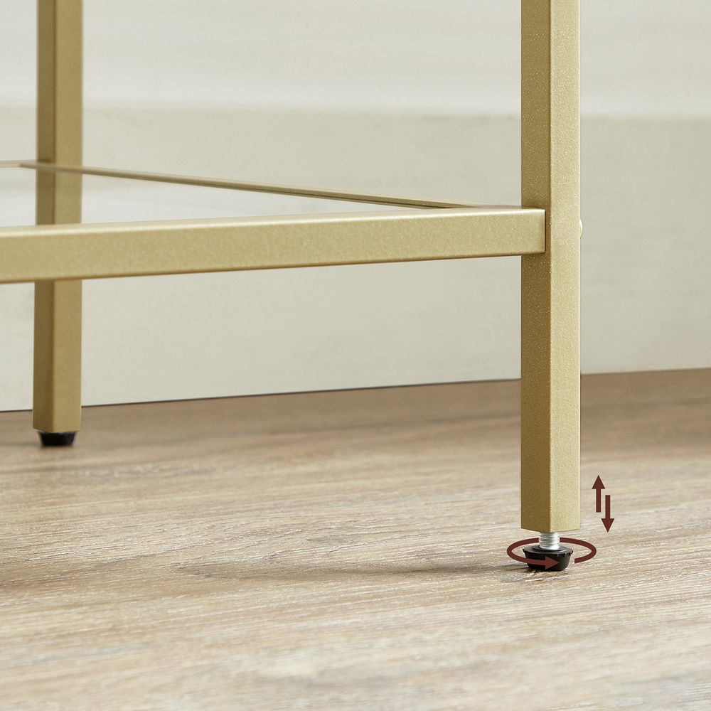 Elegant gold and glass standing shelf with a sturdy steel frame, tempered glass shelves, and versatile storage for any room.


