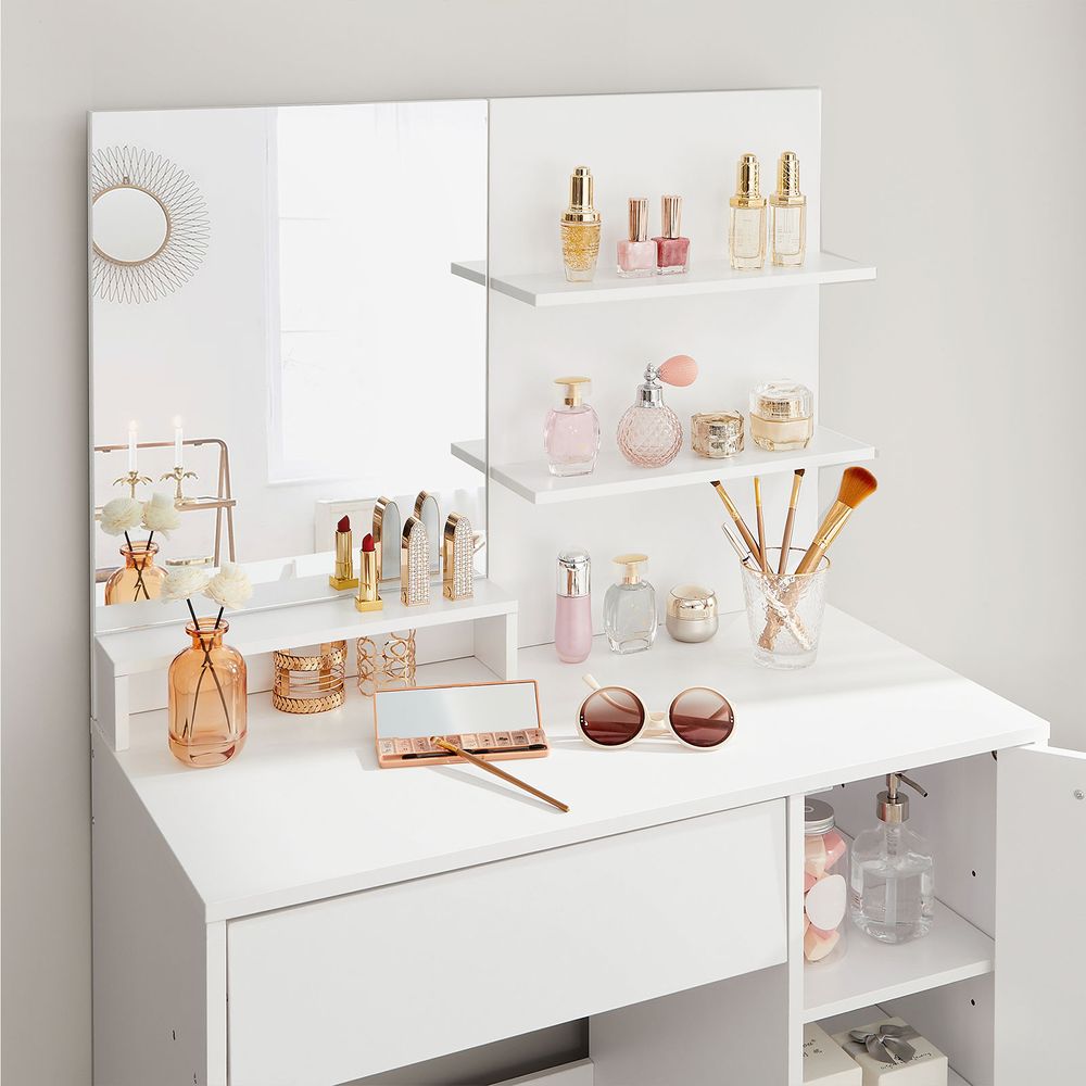 Elegant white dressing table with a frameless mirror, shelves for lipsticks and creams, a drawer for eye shadows and brushes, and a cupboard for skincare products. The sleek design and smooth lacquer coating make it a timeless addition to any room.






