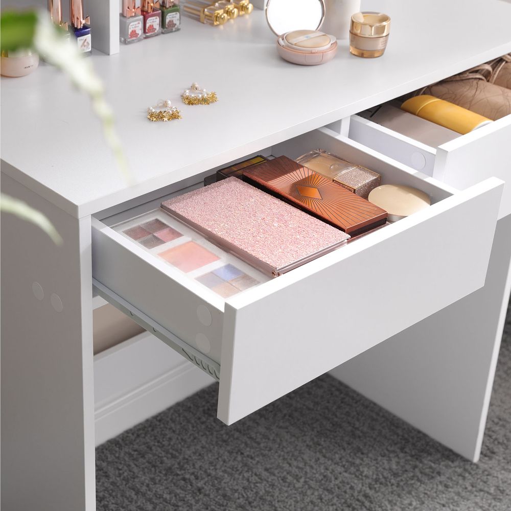 Classy white makeup dresser featuring a tri-fold mirror, two large drawers for cosmetics, three open compartments for nail polish, and a raised shelf for perfumes. Made with stain-resistant chipboard and melamine coating for durability and easy maintenance.