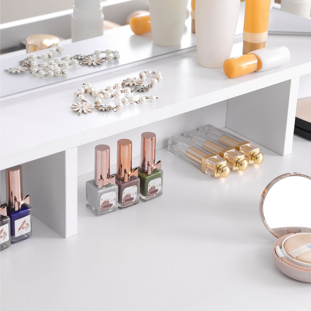 Classy white makeup dresser featuring a tri-fold mirror, two large drawers for cosmetics, three open compartments for nail polish, and a raised shelf for perfumes. Made with stain-resistant chipboard and melamine coating for durability and easy maintenance.